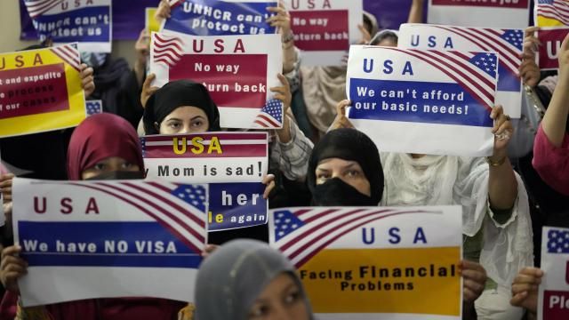 FILE - Afghan refugees hold placards during a gathering in Islamabad, Pakistan, July 21, 2023. Senators from both parties are urging congressional leaders to ensure that more visas are made available to Afghans who worked alongside U.S. troops in America's longest war. The senators say an additional 20,000 visas are needed before the end of the fiscal year in September. (AP Photo/Rahmat Gul, File) FILE - Afghan refugees hold placards during a gathering in Islamabad, Pakistan, July 21, 2023. Senators from both parties are urging congressional leaders to ensure that more visas are made available to Afghans who worked alongside U.S. troops in America's longest war. The senators say an additional 20,000 visas are needed before the end of the fiscal year in September. (AP Photo/Rahmat Gul, File)