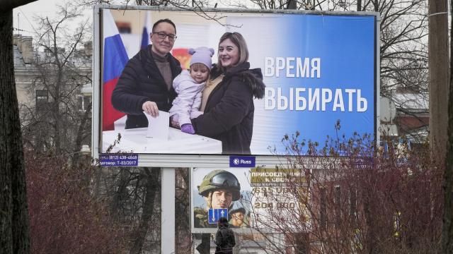FILE - A woman walks past a billboard promoting the upcoming presidential election with the words "Time to vote" in Russian, in St. Petersburg, Russia, on March 7, 2024. People are heading to the polls for a three-day vote that is all but certain to extend President Vladimir Putin's rule after he clamped down on dissent. (AP Photo, File) FILE - A woman walks past a billboard promoting the upcoming presidential election with the words "Time to vote" in Russian, in St. Petersburg, Russia, on March 7, 2024. People are heading to the polls for a three-day vote that is all but certain to extend President Vladimir Putin's rule after he clamped down on dissent. (AP Photo, File)