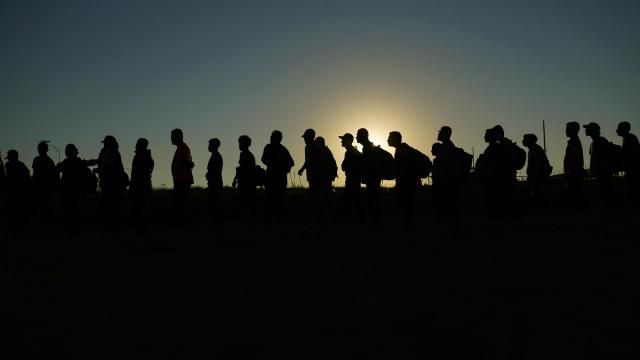 FILE - Migrants who crossed the Rio Grande and entered the U.S. from Mexico are lined up for processing by U.S. Customs and Border Protection, Sept. 23, 2023, in Eagle Pass, Texas. A federal judge on Thursday, Feb. 29, 2024 blocked a new Texas law that gives police broad powers to arrest migrants suspected of illegally entering the U.S., dealing a victory to the Biden administration in its feud with Republican Gov. Greg Abbott over immigration enforcement. (AP Photo/Eric Gay, file) FILE - Migrants who crossed the Rio Grande and entered the U.S. from Mexico are lined up for processing by U.S. Customs and Border Protection, Sept. 23, 2023, in Eagle Pass, Texas. A federal judge on Thursday, Feb. 29, 2024 blocked a new Texas law that gives police broad powers to arrest migrants suspected of illegally entering the U.S., dealing a victory to the Biden administration in its feud with Republican Gov. Greg Abbott over immigration enforcement. (AP Photo/Eric Gay, file)