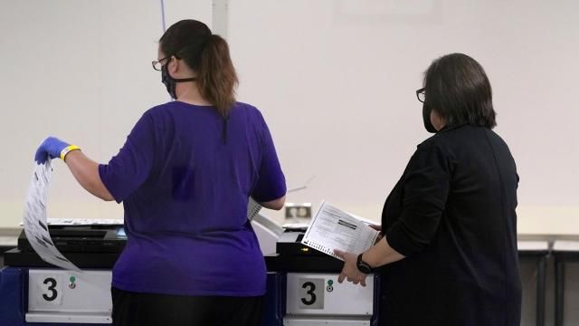 FILE - Maricopa County Elections Department officials feed test ballots into tabulating machines, Nov. 18, 2020, in Phoenix. Arizona's top election officials are taking an aggressive approach to combating disinformation and responding to threats against election workers in a state that has been an epicenter of both. Their efforts are ramping up in anticipation of another razor-thin presidential contest in a state where false voting claims have run rampant for the past four years. (AP Photo/Ross D. Franklin, File) FILE - Maricopa County Elections Department officials feed test ballots into tabulating machines, Nov. 18, 2020, in Phoenix. Arizona's top election officials are taking an aggressive approach to combating disinformation and responding to threats against election workers in a state that has been an epicenter of both. Their efforts are ramping up in anticipation of another razor-thin presidential contest in a state where false voting claims have run rampant for the past four years. (AP Photo/Ross D. Franklin, File)