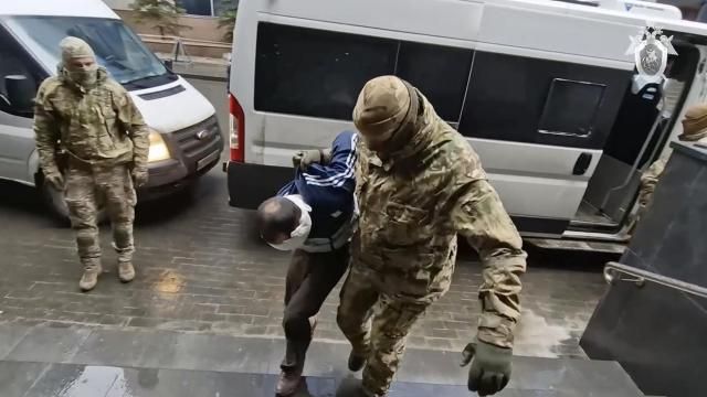 In this photo taken from video released by Investigative Committee of Russia on Sunday, March 24, 2024, a suspect in the Crocus City Hall shooting on Friday is escorted to the Russian Investigative Committee headquarters in Moscow, Russia. (Investigative Committee of Russia via AP) In this photo taken from video released by Investigative Committee of Russia on Sunday, March 24, 2024, a suspect in the Crocus City Hall shooting on Friday is escorted to the Russian Investigative Committee headquarters in Moscow, Russia. (Investigative Committee of Russia via AP)