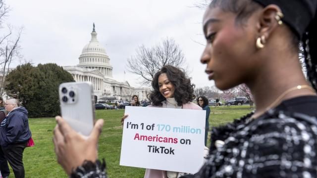 FILE - Devotees of TikTok, Mona Swain, center, and her sister, Rachel Swain, right, both of Atlanta, pose with a sign at the Capitol in Washington, March 13, 2024. TikTok's extensive lobbying campaign is the latest tech industry push since the House passed legislation that would ban the popular app if its China-based owner doesn't sell its stake. TikTok has been urging its users to call their representatives. (AP Photo/J. Scott Applewhite, File) FILE - Devotees of TikTok, Mona Swain, center, and her sister, Rachel Swain, right, both of Atlanta, pose with a sign at the Capitol in Washington, March 13, 2024. TikTok's extensive lobbying campaign is the latest tech industry push since the House passed legislation that would ban the popular app if its China-based owner doesn't sell its stake. TikTok has been urging its users to call their representatives. (AP Photo/J. Scott Applewhite, File)