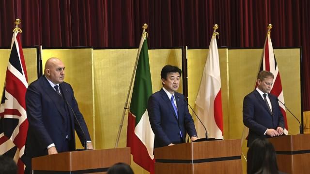 FILE - Britain's Defense Minister Grant Shapps, right, Italy's Defense Minister Guido Crosetto, left, and Japanese Defense Minister Minoru Kihara, center, attend a joint press conference after a signing ceremony for Global Combat Air Programme (GCAP) at the defense ministry on Dec. 14, 2023, in Tokyo, Japan. Japan’s Cabinet on Tuesday, March 26, 2024, approved a plan to sell future next-generation fighter jets that it’s developing with Britain and Italy to other countries, in the latest move away from the country’s postwar pacifist principles. (David Mareuil/Pool Photo via AP, File) FILE - Britain's Defense Minister Grant Shapps, right, Italy's Defense Minister Guido Crosetto, left, and Japanese Defense Minister Minoru Kihara, center, attend a joint press conference after a signing ceremony for Global Combat Air Programme (GCAP) at the defense ministry on Dec. 14, 2023, in Tokyo, Japan. Japan’s Cabinet on Tuesday, March 26, 2024, approved a plan to sell future next-generation fighter jets that it’s developing with Britain and Italy to other countries, in the latest move away from the country’s postwar pacifist principles. (David Mareuil/Pool Photo via AP, File)