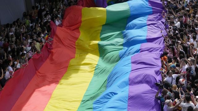 FILE - Participants hold a rainbow flag during a Pride Parade in Bangkok, Thailand, on June 4, 2023. Lawmakers in Thailand's lower house of Parliament overwhelmingly approved a marriage equality bill on Wednesday, March 27, 2024, that would make the country the first in Southeast Asia to legalize equal rights for marriage partners of any gender. (AP Photo/Sakchai Lalit, File) FILE - Participants hold a rainbow flag during a Pride Parade in Bangkok, Thailand, on June 4, 2023. Lawmakers in Thailand's lower house of Parliament overwhelmingly approved a marriage equality bill on Wednesday, March 27, 2024, that would make the country the first in Southeast Asia to legalize equal rights for marriage partners of any gender. (AP Photo/Sakchai Lalit, File)