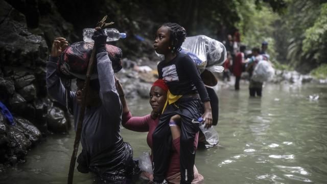 FILE - Haitian migrants wade through water as they cross the Darien Gap from Colombia to Panama in hopes of reaching the United States, May 9, 2023. Colombia and Panama are failing to protect hundreds of thousands of migrants who are crossing the Darien jungle on their way to the U.S. and have become increasingly vulnerable to robberies and sexual violence, Human Rights Watch said in a report published Wednesday, April 3, 2024. (AP Photo/Ivan Valencia, File) FILE - Haitian migrants wade through water as they cross the Darien Gap from Colombia to Panama in hopes of reaching the United States, May 9, 2023. Colombia and Panama are failing to protect hundreds of thousands of migrants who are crossing the Darien jungle on their way to the U.S. and have become increasingly vulnerable to robberies and sexual violence, Human Rights Watch said in a report published Wednesday, April 3, 2024. (AP Photo/Ivan Valencia, File)