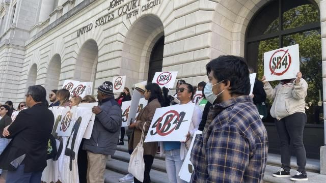 Demonstrators gather outside federal court buildings in New Orleans on Wednesday, April 3, 2024, to protest a Texas law known as SB4. Texas officials appeared before a three-judge federal appeals panel to defend a state law that would allow police to arrest migrants for illegally entering the United States, a week after the same three judges put the law on hold. (AP Photo by Kevin McGill) Demonstrators gather outside federal court buildings in New Orleans on Wednesday, April 3, 2024, to protest a Texas law known as SB4. Texas officials appeared before a three-judge federal appeals panel to defend a state law that would allow police to arrest migrants for illegally entering the United States, a week after the same three judges put the law on hold. (AP Photo by Kevin McGill)