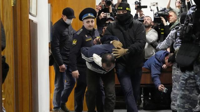 FILE - Saidakrami Murodali Rachabalizoda, a suspect in the Crocus City Hall shootings, is escorted by police and FSB officers in Basmanny District Court in Moscow, Russia, on March 24, 2024. The attack on the Moscow concert hall, the bloodiest assault on Russian soil in two decades, appears to be setting the stage for an increasingly harsh response by President Vladimir Putin. Four suspects in the attack appeared in court showing signs of brutal treatment while in custody. (AP Photo/Alexander Zemlianichenko, File) FILE - Saidakrami Murodali Rachabalizoda, a suspect in the Crocus City Hall shootings, is escorted by police and FSB officers in Basmanny District Court in Moscow, Russia, on March 24, 2024. The attack on the Moscow concert hall, the bloodiest assault on Russian soil in two decades, appears to be setting the stage for an increasingly harsh response by President Vladimir Putin. Four suspects in the attack appeared in court showing signs of brutal treatment while in custody. (AP Photo/Alexander Zemlianichenko, File)