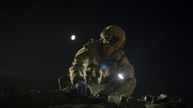 Oleksii Yukov examines the body of a Russian soldier he collected on the frontline in the Sloviansk region, Ukraine, Tuesday, Oct. 24, 2023. The 38-year-old martial arts instructor leads a team of volunteer body collectors in Ukraine. (AP Photo/Bram Janssen) Oleksii Yukov examines the body of a Russian soldier he collected on the frontline in the Sloviansk region, Ukraine, Tuesday, Oct. 24, 2023. The 38-year-old martial arts instructor leads a team of volunteer body collectors in Ukraine. (AP Photo/Bram Janssen)