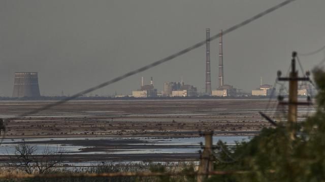 FILE - The Zaporizhzhia nuclear power plant, Europe's largest, is seen in the background of the shallow Kakhovka Reservoir after the dam collapse, in Energodar, Russian-occupied Ukraine, Tuesday, June 27, 2023. Officials at the Russian-controlled Zaporizhzhia Nuclear Power Plant said that the site was attacked Sunday April 7, 2024, by Ukrainian military drones, including a strike on the dome of the plant’s sixth power unit. (AP Photo/Libkos, File) FILE - The Zaporizhzhia nuclear power plant, Europe's largest, is seen in the background of the shallow Kakhovka Reservoir after the dam collapse, in Energodar, Russian-occupied Ukraine, Tuesday, June 27, 2023. Officials at the Russian-controlled Zaporizhzhia Nuclear Power Plant said that the site was attacked Sunday April 7, 2024, by Ukrainian military drones, including a strike on the dome of the plant’s sixth power unit. (AP Photo/Libkos, File)