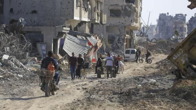 Palestinians walk through the destruction left by the Israeli air and ground offensive after they withdrew from Khan Younis, southern Gaza Strip, Sunday, April 7, 2024. (AP Photo/Ismael Abu Dayyah) Palestinians walk through the destruction left by the Israeli air and ground offensive after they withdrew from Khan Younis, southern Gaza Strip, Sunday, April 7, 2024. (AP Photo/Ismael Abu Dayyah)