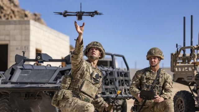 In this photo from the Defense Visual Information Distribution Service, British soldiers launch a drone during Project Convergence exercises at Fort Irwin, Calif., on Nov. 4, 2022. With tensions high over Taiwan, U.S. and Chinese military planners are readying themselves for a new kind of war where battleships, fighter jets and amphibious landings cede prevalence to squadrons of AI-enabled air and sea drones. (DVIDS via AP) In this photo from the Defense Visual Information Distribution Service, British soldiers launch a drone during Project Convergence exercises at Fort Irwin, Calif., on Nov. 4, 2022. With tensions high over Taiwan, U.S. and Chinese military planners are readying themselves for a new kind of war where battleships, fighter jets and amphibious landings cede prevalence to squadrons of AI-enabled air and sea drones. (DVIDS via AP)