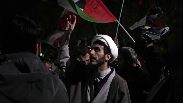 A cleric chants slogans during an anti-Israeli gathering in front of the British Embassy in Tehran, Iran, early Sunday, April 14, 2024. Iran launched its first direct military attack against Israel on Saturday. (AP Photo/Vahid Salemi) A cleric chants slogans during an anti-Israeli gathering in front of the British Embassy in Tehran, Iran, early Sunday, April 14, 2024. Iran launched its first direct military attack against Israel on Saturday. (AP Photo/Vahid Salemi)