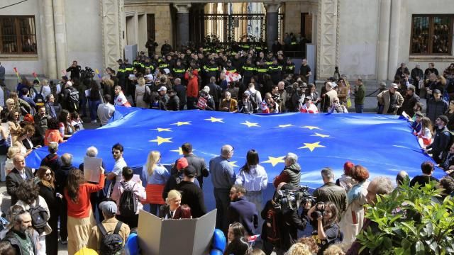 Protestors with a giant EU flag gather outside the parliament building in Tbilisi, Georgia, on Monday, April 15, 2024 to protest against the "the Russian law" as it is similar to a law that Russia uses to stigmatize independent news media and organizations seen as being at odds with the Kremlin. The governing party in the country of Georgia has submitted to parliament a draft law calling for media and non-commercial organizations to register as being under foreign influence if they receive more than 20% of their budget from abroad. (AP Photo/Shakh Aivazov) Protestors with a giant EU flag gather outside the parliament building in Tbilisi, Georgia, on Monday, April 15, 2024 to protest against the "the Russian law" as it is similar to a law that Russia uses to stigmatize independent news media and organizations seen as being at odds with the Kremlin. The governing party in the country of Georgia has submitted to parliament a draft law calling for media and non-commercial organizations to register as being under foreign influence if they receive more than 20% of their budget from abroad. (AP Photo/Shakh Aivazov)