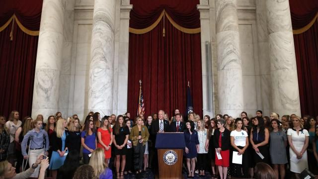 FILE - Sen. Jerry Moran, R-Kansas, center left, and Sen. Richard Blumenthal, D-Conn., attend a news conference with dozens of women and girls who were sexually abused by Larry Nassar, a former doctor for Michigan State University athletics and USA Gymnastics, July 24, 2018, on Capitol Hill in Washington. The U.S. Justice Department has agreed to pay approximately $100 million to settle claims with about 100 sexual assault victims of Nassar, a source with direct knowledge of the negotiations told The Associated Press on Wednesday, April 17, 2024. (AP Photo/Jacquelyn Martin, File)