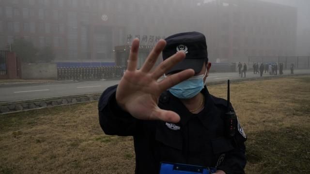 FILE - A security person moves journalists away from the Wuhan Institute of Virology after a World Health Organization team arrived for a field visit in Wuhan in China's Hubei province on Feb. 3, 2021. The hunt for COVID-19 origins has gone dark in China. An AP investigation drawing on thousands of pages of undisclosed emails and documents and dozens of interviews found feuding officials and fear of blame ended meaningful Chinese and international efforts to trace the virus almost as soon as they began, despite years of public statements to the contrary. (AP Photo/Ng Han Guan, File) FILE - A security person moves journalists away from the Wuhan Institute of Virology after a World Health Organization team arrived for a field visit in Wuhan in China's Hubei province on Feb. 3, 2021. The hunt for COVID-19 origins has gone dark in China. An AP investigation drawing on thousands of pages of undisclosed emails and documents and dozens of interviews found feuding officials and fear of blame ended meaningful Chinese and international efforts to trace the virus almost as soon as they began, despite years of public statements to the contrary. (AP Photo/Ng Han Guan, File)