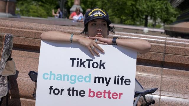 A TikTok content creator, sits outside the U.S. Capitol, Tuesday, April 23, 2024, in Washington as Senators prepare to consider legislation that would force TikTok's China-based parent company to sell the social media platform under the threat of a ban, a contentious move by U.S. lawmakers. (AP Photo/Mariam Zuhaib)