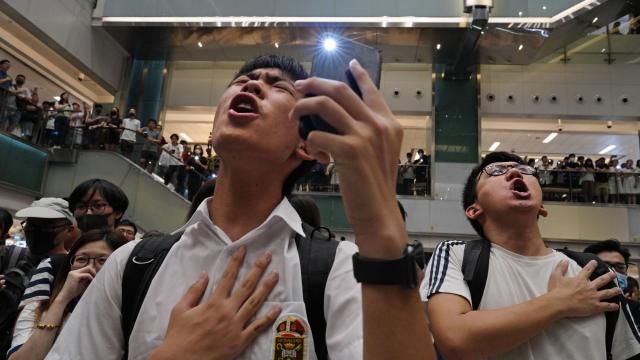 FILE - Local residents sing a theme song written by protesters "Glory to Hong Kong" at a shopping mall in Hong Kong on Sept. 11, 2019. An appeals court Wednesday, May 8, 2024 granted the Hong Kong government's request to ban a popular protest song, overturning an earlier ruling and deepening concerns over the erosion of freedoms in the once-freewheeling global financial hub. (AP Photo/Vincent Yu, File) FILE - Local residents sing a theme song written by protesters "Glory to Hong Kong" at a shopping mall in Hong Kong on Sept. 11, 2019. An appeals court Wednesday, May 8, 2024 granted the Hong Kong government's request to ban a popular protest song, overturning an earlier ruling and deepening concerns over the erosion of freedoms in the once-freewheeling global financial hub. (AP Photo/Vincent Yu, File)