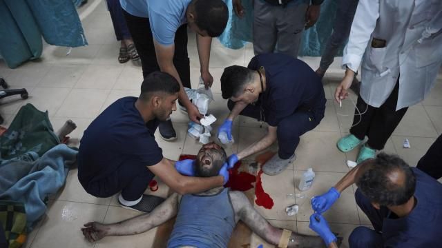 Palestinian medics treat a wounded man in the Israeli bombardment of the Gaza Strip at Al Aqsa hospital in Deir al Balah, Gaza Strip, on Saturday, May 11, 2024. (AP Photo/Saher Alghorra)
