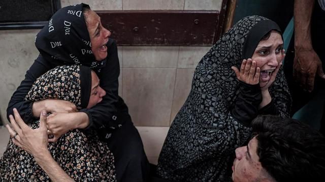 Palestinians mourn their relative killed in the Israeli bombardment of the Gaza Strip, at Al Aqsa Hospital in Deir al Balah, Gaza Strip, early Sunday, May 12, 2024. (AP Photo/Saher Alghorra)