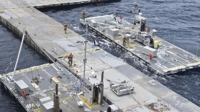 In this image provided by the U.S. Army, soldiers assigned to the 7th Transportation Brigade (Expeditionary) and sailors attached to the MV Roy P. Benavidez assemble the Roll-On, Roll-Off Distribution Facility (RRDF), or floating pier, off the shore of Gaza in the Mediterranean Sea on April 26, 2024. The pier is part of the Army's Joint Logistics Over The Shore (JLOTS) system which provides critical bridging and water access capabilities. (U.S. Army via AP, File)