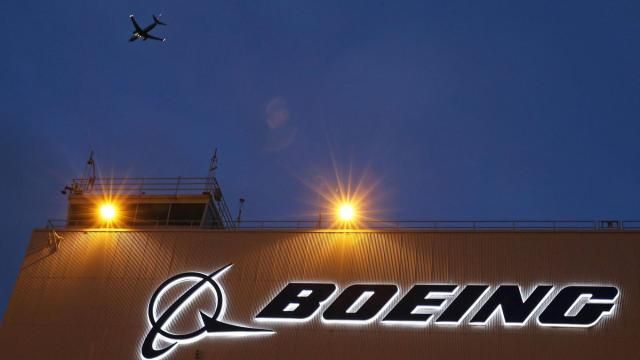FILE - An airplane flies over a sign on Boeing's 737 delivery center, Oct. 19, 2015, at Boeing Field in Seattle. The Justice Department's determination on Tuesday, May 14, 2024, that Boeing violated corporate probation for deceiving federal regulators does not necessarily mean that prosecutors will revive criminal charges against the giant aircraft manufacturer. (AP Photo/Ted S. Warren, File)