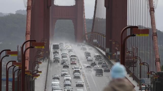 FILE -- A person watches as traffic drives across the Golden Gate Bridge in Sausalito, Calif., on March 1, 2024. The California Senate passed a bill on Tuesday, May 21, 2024, that would eventually require all new cars sold in California to alert drivers once they exceed the speed limit by 10 miles per hour. (AP Photo/Jeff Chiu,File)