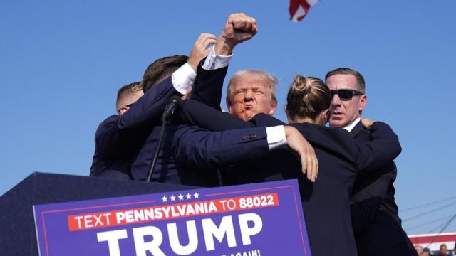 Republican presidential candidate former President Donald Trump gestures as he is surrounded by U.S. Secret Service agents at a campaign rally, Saturday, July 13, 2024, in Butler, Pa. (AP Photo/Evan Vucci)