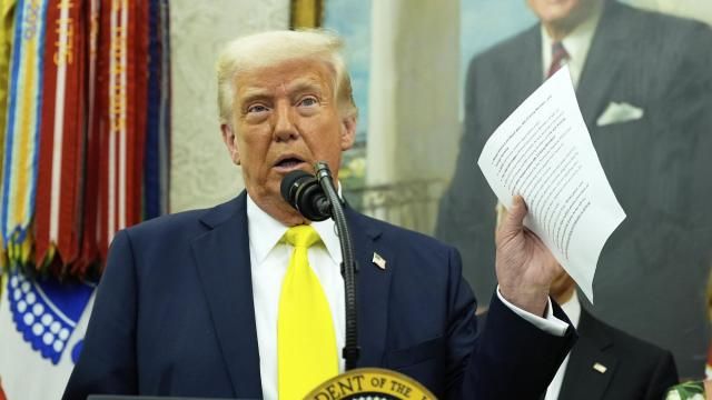 FILE - President Donald Trump holds a document with notes about Kilmar Abrego Garcia as he speaks with reporters in the Oval Office of the White House, April 18, 2025, in Washington.(AP Photo/Alex Brandon, File)
