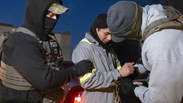 FILE - U.S. Immigration and Customs Enforcement officers use a chain to more comfortably restrain a detained person using handcuffs positioned in front, Jan. 27, 2025, in Silver Spring, Md. (AP Photo/Alex Brandon, file)