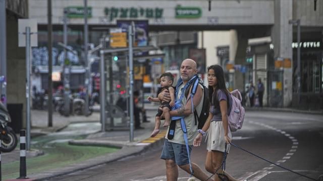 People leave an underground parking garage where they took shelter after an air raid alarm of Iranian missile attacks went off, in Tel Aviv, Israel, Tuesday, June 24, 2025. (AP Photo/Ohad Zwigenberg)