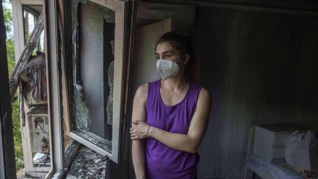 Karyna Holf, 25, stands in her apartment which was damaged by a Russian drone strike in Kyiv, Ukraine, on Thursday, July 10, 2025. (AP Photo/Evgeniy Maloletka)