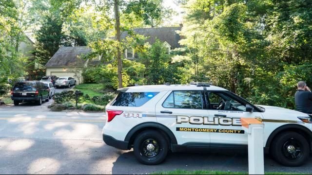 Former National Security Advisor John Bolton's house is seen with a Montgomery County, Md., police vehicle outside, as FBI agents search the home, Friday, Aug. 22, 2025 in Bethesda, Md. (AP Photo/Jose Luis Magana)