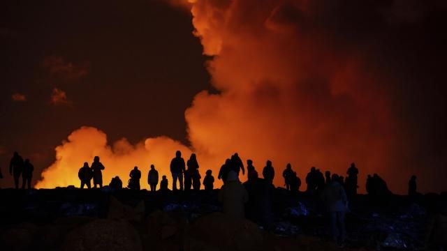 Spectators watch plumes of smoke from volcanic activity between Hagafell and Stóri-Skógfell, Iceland, on Saturday, March 16, 2024. (AP Photo/Marco di Marco) Spectators watch plumes of smoke from volcanic activity between Hagafell and Stóri-Skógfell, Iceland, on Saturday, March 16, 2024. (AP Photo/Marco di Marco)