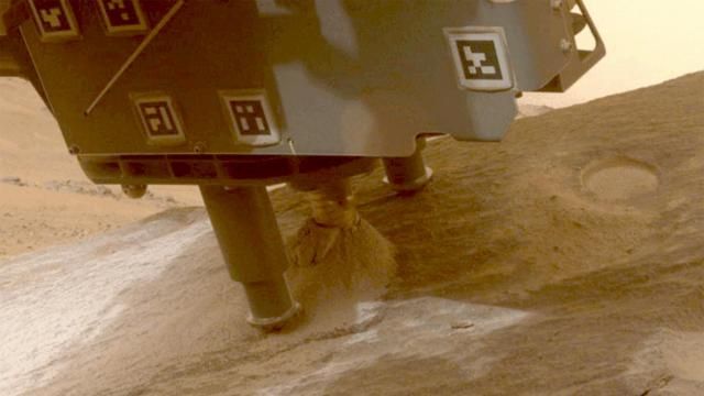 This photo provided by NASA shows the Perseverance Mars rover collecting a sample from a rock called "Bunsen Peak" using a coring bit on the end of its robotic arm on March 11, 2024. NASA has put the effort to bring the samples to Earth on hold until there is a faster, cheaper way. (NASA/JPL-Caltech/ASU via AP) This photo provided by NASA shows the Perseverance Mars rover collecting a sample from a rock called "Bunsen Peak" using a coring bit on the end of its robotic arm on March 11, 2024. NASA has put the effort to bring the samples to Earth on hold until there is a faster, cheaper way. (NASA/JPL-Caltech/ASU via AP)