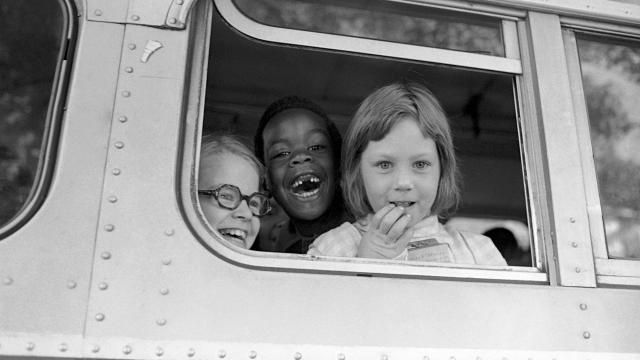 FILE - Children smile from window of a school bus in Springfield, Mass., as court-ordered busing brought Black children and white children together in elementary grades without incident, Sept. 16, 1974. Friday, May 17, 2024, marks 70 years since the U.S. Supreme Court ruled that separating children in schools by race was unconstitutional. On paper, Brown v. Board of Education still stands. In reality, school integration is all but gone, the victim of a gradual series of court cases that slowly eroded it, leaving little behind. (AP Photo/Peter Bregg, File)
