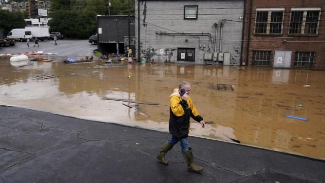 FILE - A man walks near a flooded area near the Swannanoa river, effects from Hurricane Helene , Friday, Sept. 27, 2024, in Asheville, N.C. (AP Photo/Erik Verduzco, File)