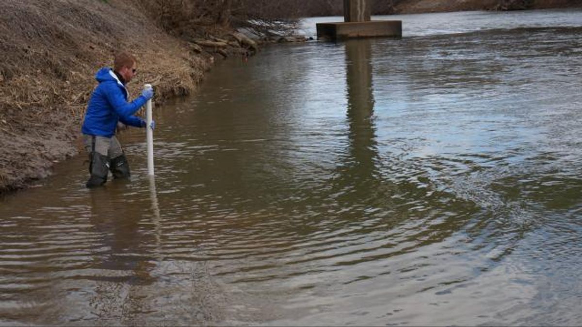 Pete Harrison takes a core sample of the Dan River