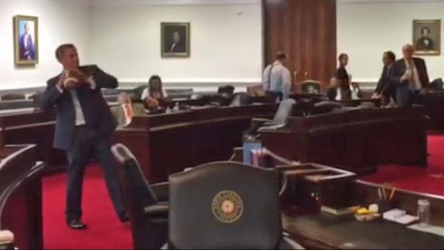 Raw: Lawmakers pass time by passing pigskin 