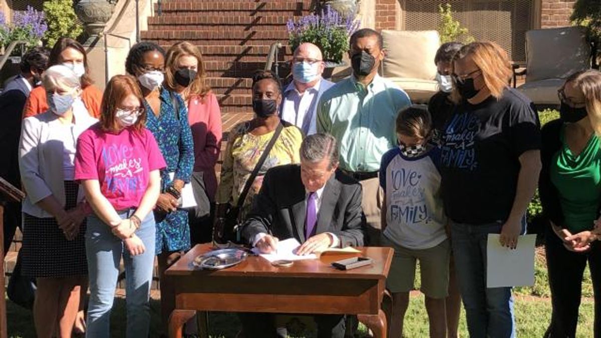 Gov. Roy Cooper signs a bill on foster parent rights, Sept. 10, 2021.