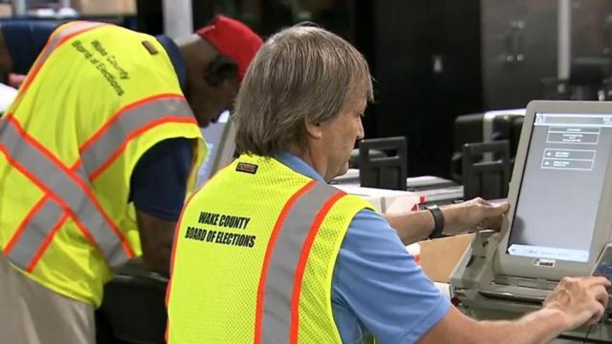 Election officials conducting accuracy tests on machines