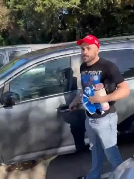 A video shows a man and woman confronting a man with crumpled Harris-Walz signs in his hands as he's getting in his Honda van.