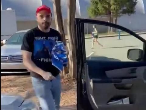A video shows a man and woman confronting a man with crumpled Harris-Walz signs in his hands as he's getting in his Honda van.