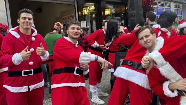 Revelers take part in the annual SantaCon charity pub crawl on Saturday, Dec. 9, 2023 in New York. Thousands of people dressed as jolly Old St. Nick have descended on New York City that kicked off early Saturday morning in bars in midtown Manhattan. (AP Photo/Andrew Meldrum)