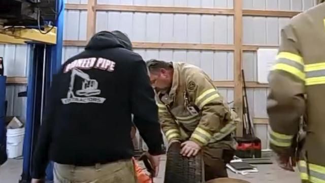 In this image take from police body worn camera video provided by the Franklin Township, N.J., Police Department, Franklinville Volunteer Fire Company members try to remove a dog who got stuck in the middle of the tire rim, Thursday, March 21, 2024, in Franklinville, N.J. The fire company said Lt. Brandon Volpe used plasma cutters to cut through the wheel and free Daisy, an 11-month-old yellow Labrador. (Franklin Township Police Department via AP) In this image take from police body worn camera video provided by the Franklin Township, N.J., Police Department, Franklinville Volunteer Fire Company members try to remove a dog who got stuck in the middle of the tire rim, Thursday, March 21, 2024, in Franklinville, N.J. The fire company said Lt. Brandon Volpe used plasma cutters to cut through the wheel and free Daisy, an 11-month-old yellow Labrador. (Franklin Township Police Department via AP)