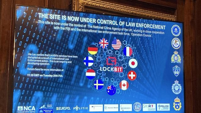 A TV screen shows the front page of LockBit's dark-web leak site that was replaced with the words "this site is now under control of law enforcement," alongside the flags of the U.K., the U.S. and several other nations during the law enforcement press conference to outline the details of a law enforcement operation against the ransomware syndicate LockBit in London, Tuesday, Feb. 20, 2024. Law-enforcement agencies said they infiltrated and disrupted LockBit, arresting two people involved with the prolific ransomware syndicate that has extracted $120 million from thousands of victims around the world. (AP Photo/Kelvin Chan) A TV screen shows the front page of LockBit's dark-web leak site that was replaced with the words "this site is now under control of law enforcement," alongside the flags of the U.K., the U.S. and several other nations during the law enforcement press conference to outline the details of a law enforcement operation against the ransomware syndicate LockBit in London, Tuesday, Feb. 20, 2024. Law-enforcement agencies said they infiltrated and disrupted LockBit, arresting two people involved with the prolific ransomware syndicate that has extracted $120 million from thousands of victims around the world. (AP Photo/Kelvin Chan)