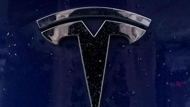FILE - A Tesla electric vehicle emblem is affixed to a passenger vehicle Sunday, Feb. 21, 2021, in Boston. The lawyers who successfully argued that a massive pay package for Tesla CEO Elon Musk was illegal and should be voided have asked the presiding judge to award them company stock worth $5.6 billion as legal fees. The attorneys, who represented Tesla shareholders in the case decided in January, made the request of the Delaware judge in court papers filed Friday, March 1, 2024. (AP Photo/Steven Senne) FILE - A Tesla electric vehicle emblem is affixed to a passenger vehicle Sunday, Feb. 21, 2021, in Boston. The lawyers who successfully argued that a massive pay package for Tesla CEO Elon Musk was illegal and should be voided have asked the presiding judge to award them company stock worth $5.6 billion as legal fees. The attorneys, who represented Tesla shareholders in the case decided in January, made the request of the Delaware judge in court papers filed Friday, March 1, 2024. (AP Photo/Steven Senne)