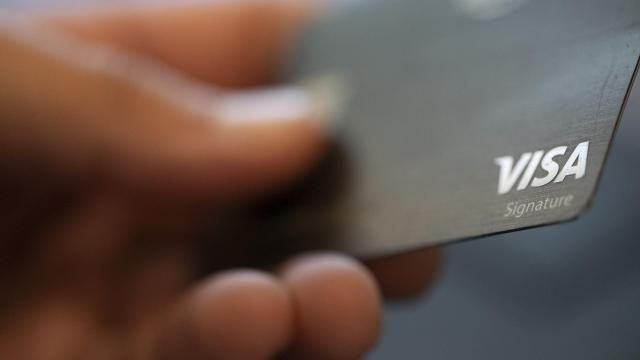 FILE - A Visa logo is displayed on a credit card in New Orleans, Aug. 11, 2019. (AP Photo/Jenny Kane, File)
