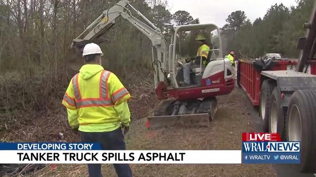 Crash spills hot asphalt into north Raleigh pond