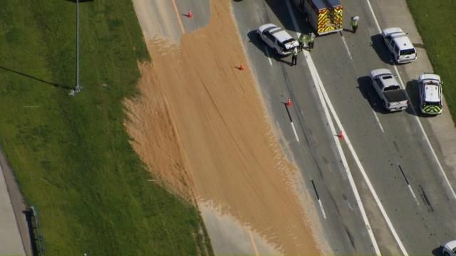 Truck overturns on Triangle Expressway near Apex, debris blocking roadway