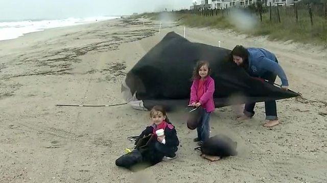 Family won't let Sandy spoil beach fun